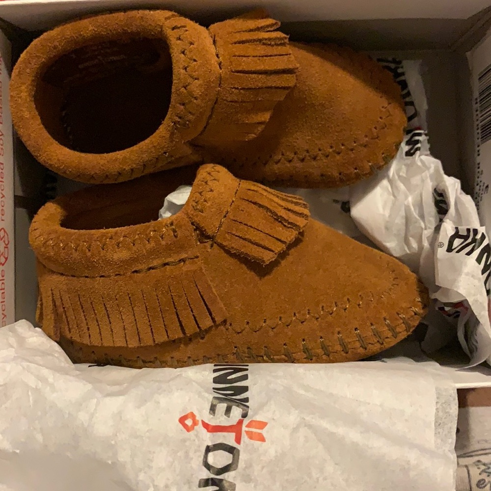 A pair of baby shoes a size three never worn!